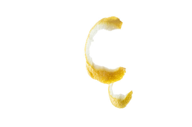 Peeled lemon peel isolate. Lemon peel on a white background. Thin skin of a lemon. Front view.