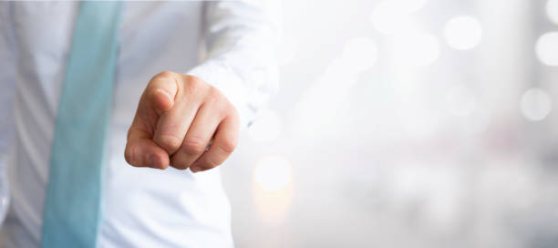 istock business man points his finger in our direction 1377946396