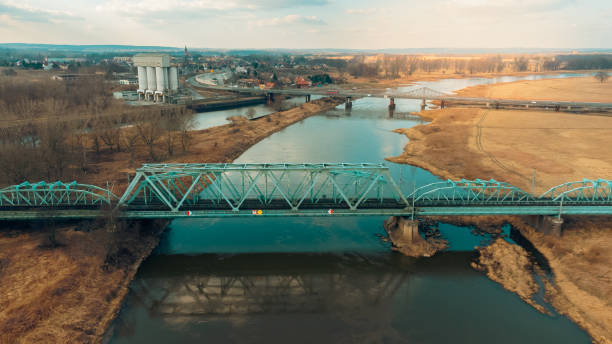 istock Blue railway bridge over the river Oder, Scinawa, Poland.  City view area drone photo 1377950433
