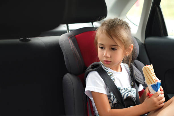 istock A child, holds a bun with a sausage in his hands. 1377955258