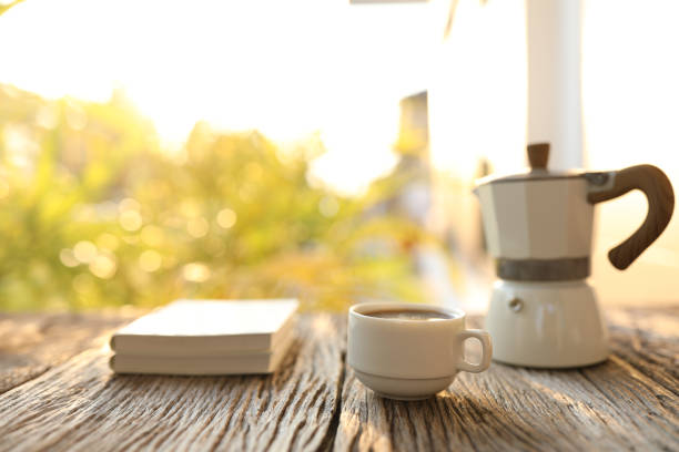istock Coffee cup and white moka pot and notebooks 1377976624