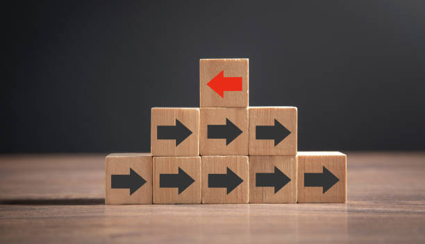 istock Red arrow opposite to black arrows direction. 1377977158