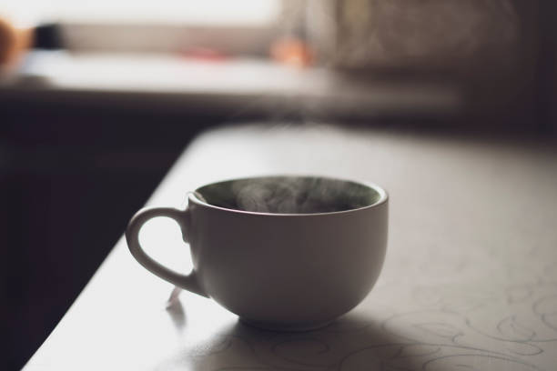 istock cup of hot drink on the table with aromatic steam 1377996602