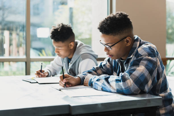 istock Teen boys concentrate on test taking 1378027620