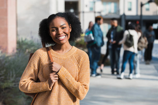Before joining friends on field trip, teen smiles for camera Before joining her classmates on the field trip, the female high school student smiles for a photo. back to school teens stock pictures, royalty-free photos & images