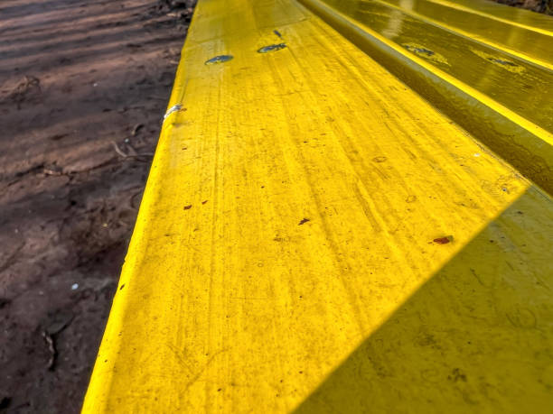 The beam of a bench painted yellow.