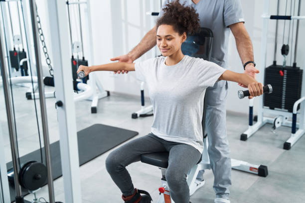 istock Young lady undergoing arm rehabilitation in the gym 1378047308
