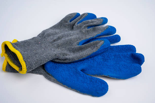 istock blue rubberized work gloves lie on a white background. construction and repair 1378055300