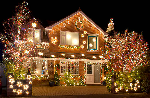 Christmas Lights Christmas Lights outside on a house and in the garden christmas lights house stock pictures, royalty-free photos & images