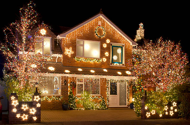 Christmas Lights Christmas Lights outside on a house and in the garden fairy lights stock pictures, royalty-free photos & images