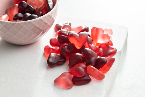 A bowl of chocolate valentine candy sitting on a table