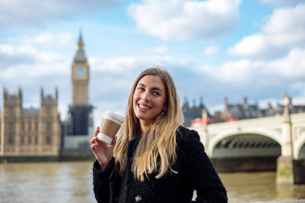 istock Young woman drinking coffee in a disposable cup at Westminster 1378072571