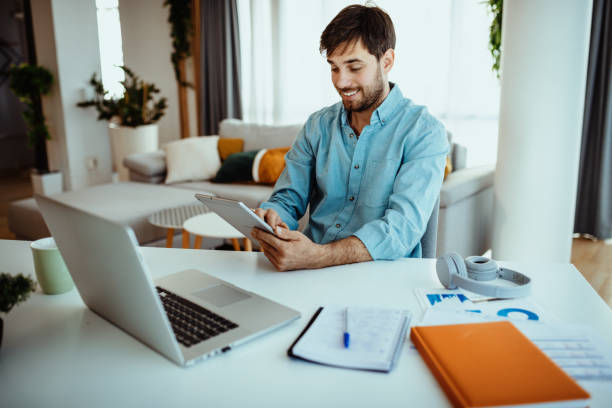 istock Man using laptop for business at home 1378077424
