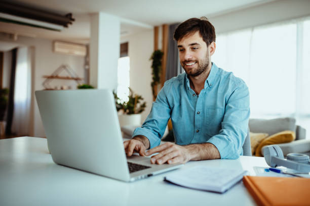 istock Man using laptop for business at home 1378077426