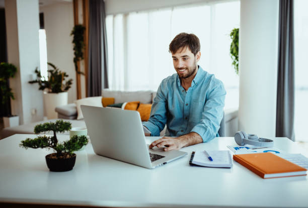 istock Man using laptop for business at home 1378077988