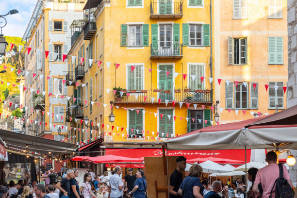 a busy, crowded and colorful place rossetti square with busy shops and cafes in the old town vieux nice district of nice, france, on the french riviera. - city of nice restaurant france french riviera imagens e fotografias de stock