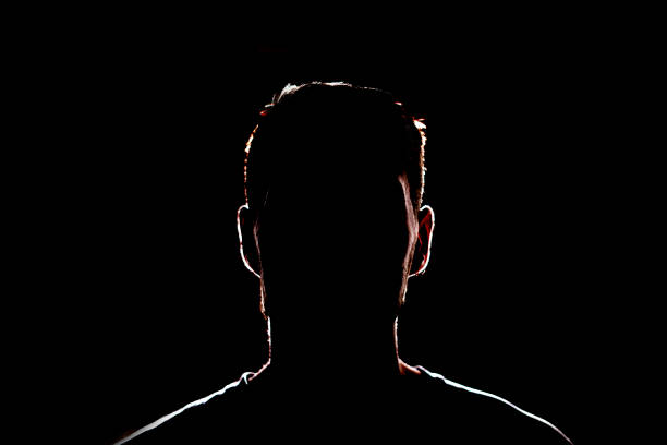 istock dark backlight shadow silhouette of male person, incognito unknown profile 1378085010