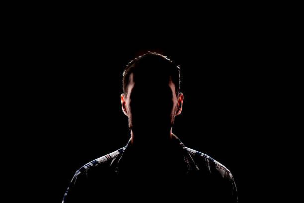 istock isolated dark male silhouette in the shadow, studio portrait 1378085014
