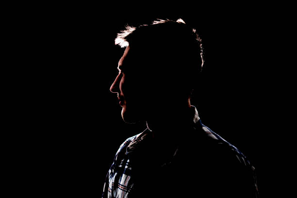 istock isolated dark male silhouette in the shadow, studio portrait 1378085027