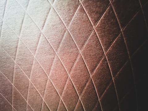 A macro image of a brown and patterned cardboard box.