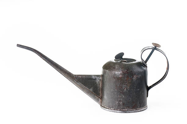 Closeup and side view of a 3 inch tall (7.5cm) metal vintage pump oil can with a long spout.