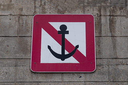 Sign prohibiting swimming in the Atlantic Ocean at the rocky coast in Cape Town