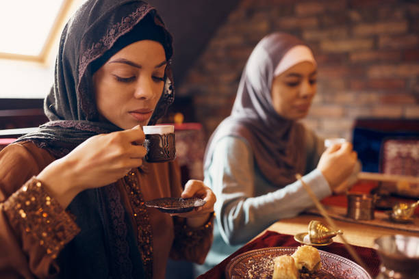 istock Young Middle Eastern woman drinking Turkish coffee during dessert at home. 1378098890