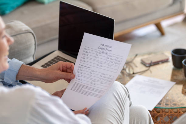 istock Mature couple doing paperwork looking at an insurance claim form 1378099138