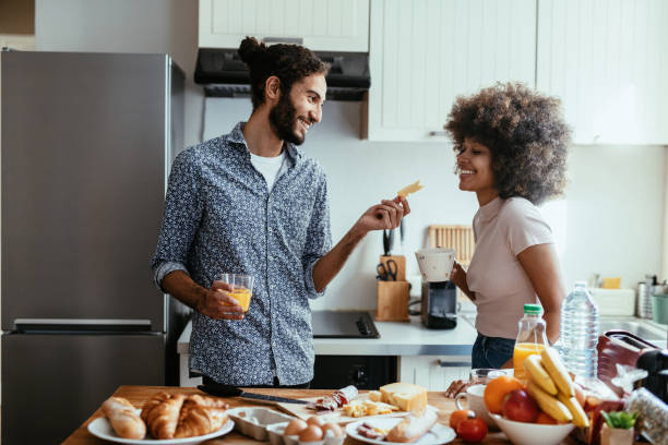istock Diverse couple preparing food in kitchen 1378114159