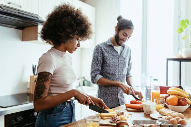 istock Middle Eastern man helping his African American woman while preparing breakfast 1378114160