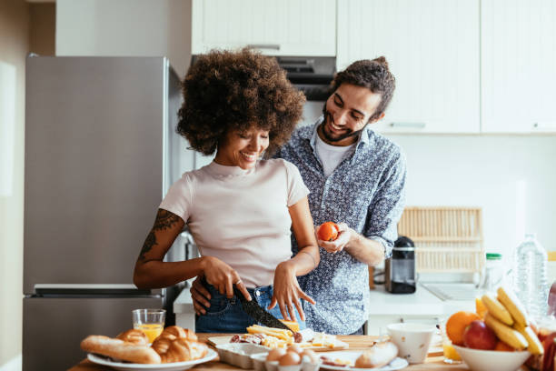 istock Teamwork in kitchen - Middle Eastern man helping his African American woman while preparing dinner 1378116798