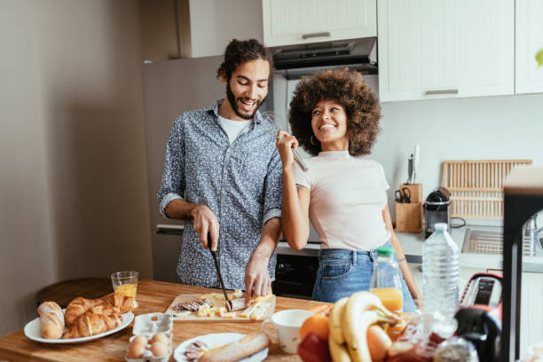 istock Multiracial heterosexual couple in kitchen singing and cooking 1378117068