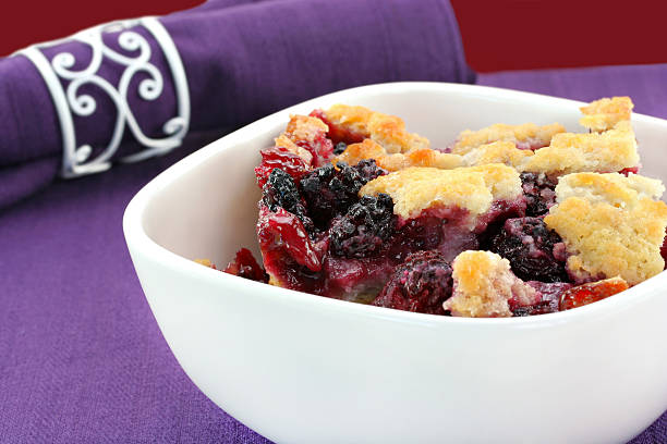 Berry cobbler, freshly made, in a white bowl.