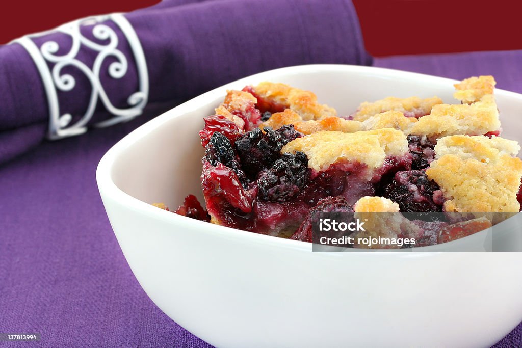 Berry cobbler in a bowl. Berry cobbler, freshly made, in a white bowl. Cobbler - Dessert Stock Photo