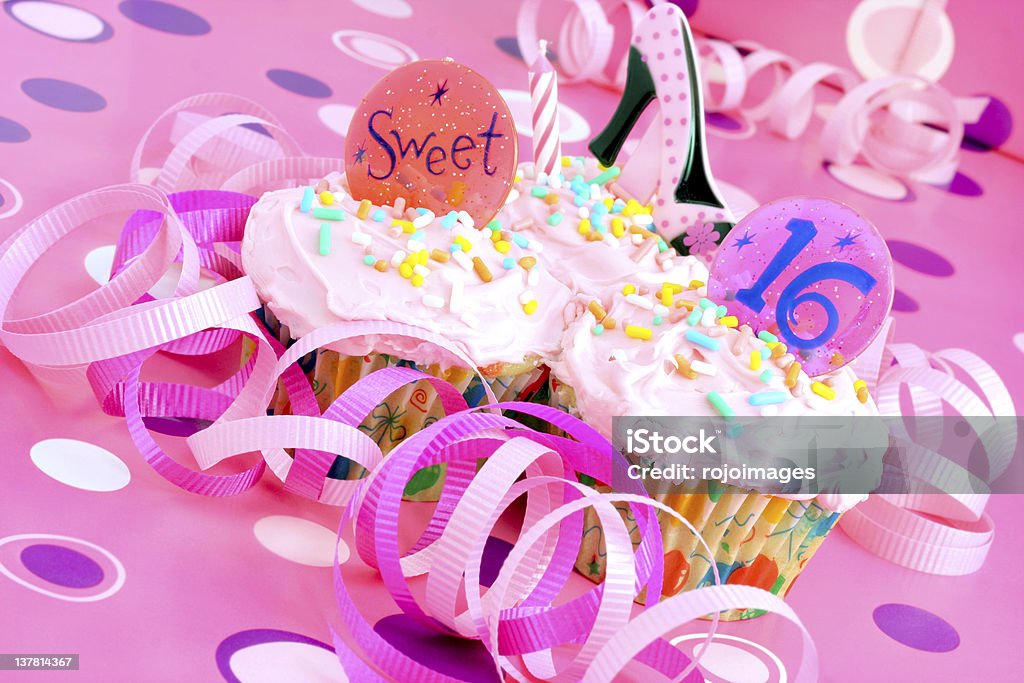 Pink Sweet Sixteen Party Cupcakes Two pink cupcakes with Sweet 16 on them in a pink feminine setting. Party - Social Event Stock Photo