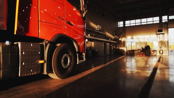 Panorama view on red lorry with cargo trailer pulls into the service station for annual service. Lorry truck service station
