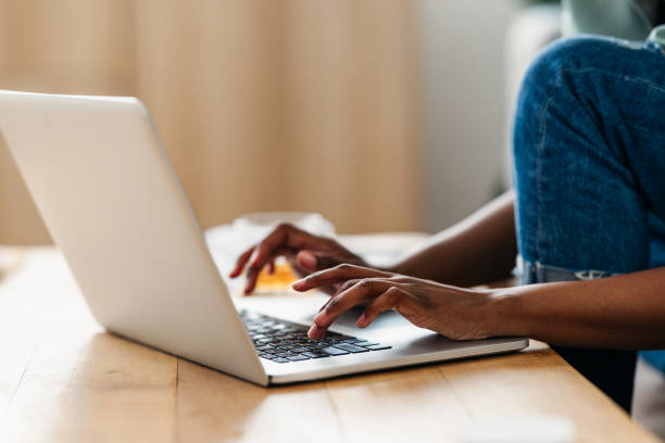istock Home Office: Anonymous Afro-American Woman Typing on a Laptop 1378157909