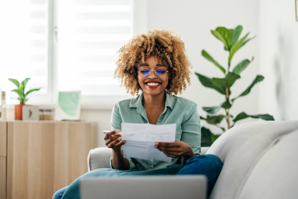 istock Portrait of a Beautiful Woman Looking at a Document While Working on her Laptop 1378158028