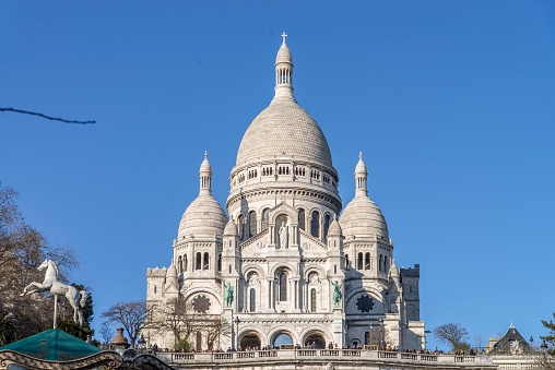 General view of the Basilica of the Sacred Heart of Paris (Basilica Sacred Coeur) at the top of Montmartre in Paris, France. It is the second place most visited by tourists in Paris.