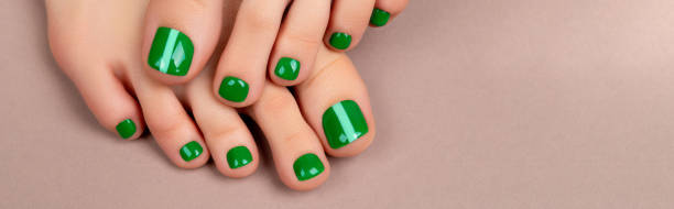 istock Womans feet with green nail polish on brown background 1378158331