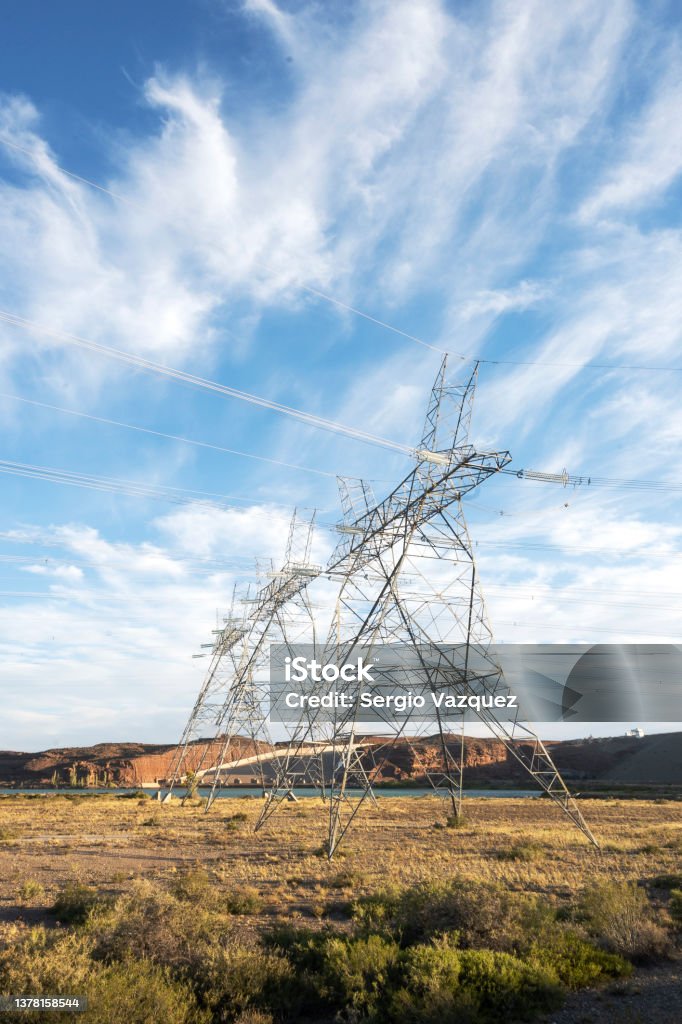high voltage towers in a hydroelectric dam high voltage towers on a hydroelectric dam to distribute electricity in patagonia Fuel and Power Generation Stock Photo