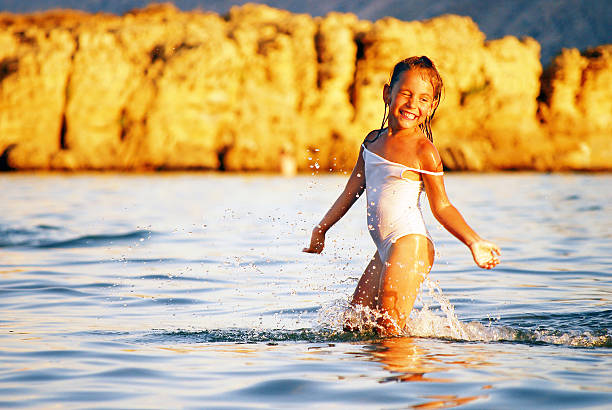 little girl playing in the sea