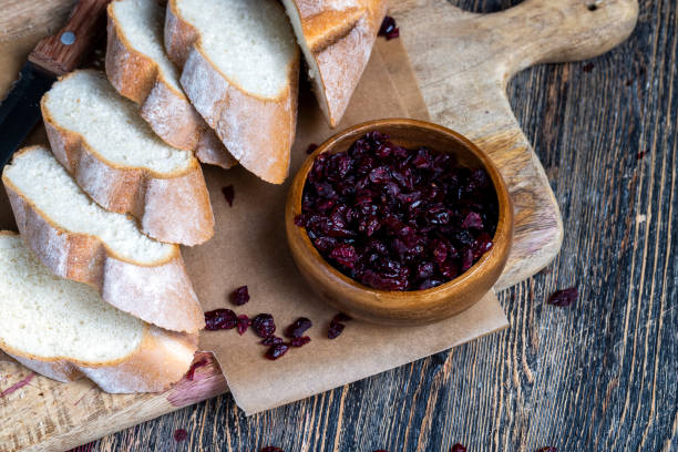 istock cranberry and sliced soft fresh baguette on a cutting board and table 1378217670