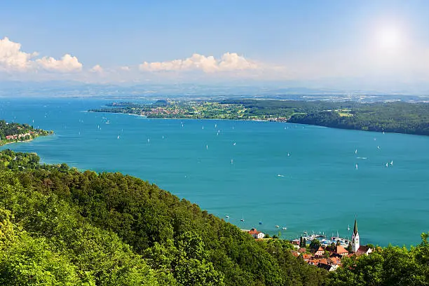 View on Lake Constance Bodensee with blue sky and the Alps in background