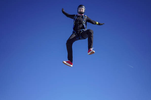 istock Female skydiver falls through clear skies, aerial flight 1378246676