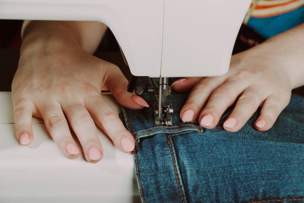 istock Woman designer or tailor working on sewing machine. World tailors day. 1378250922