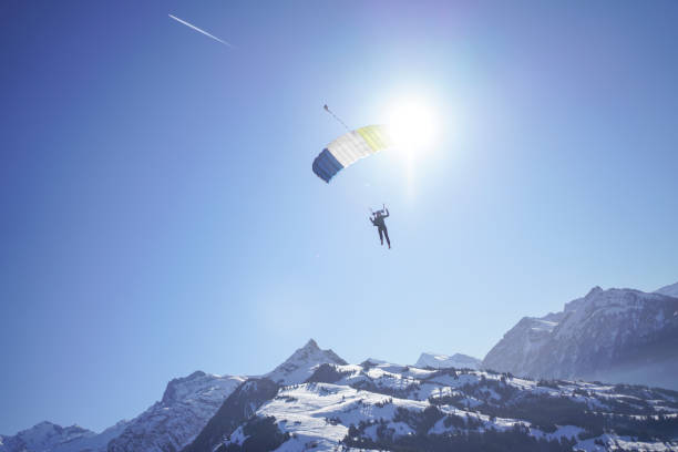 istock Female paraglider glides through clear skies 1378256608