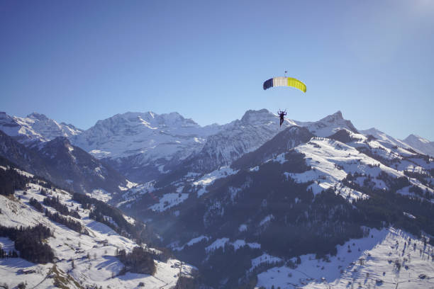 istock Female paraglider glides through clear skies 1378257141