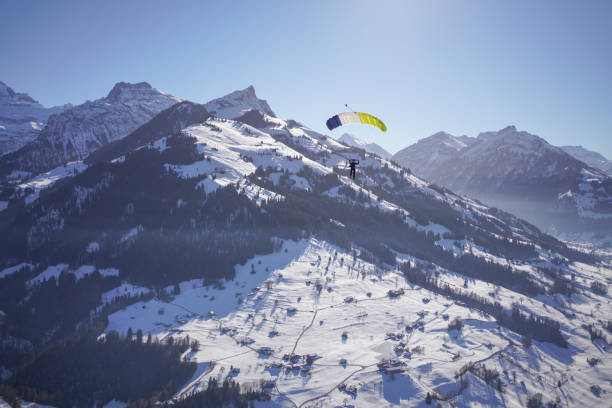 istock Female paraglider glides through clear skies 1378257142