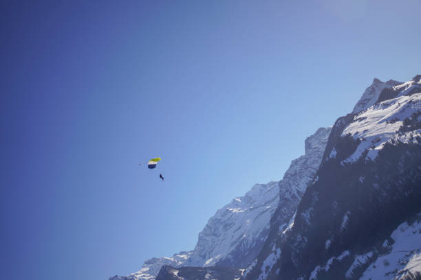 istock Female paraglider glides through clear skies 1378259209